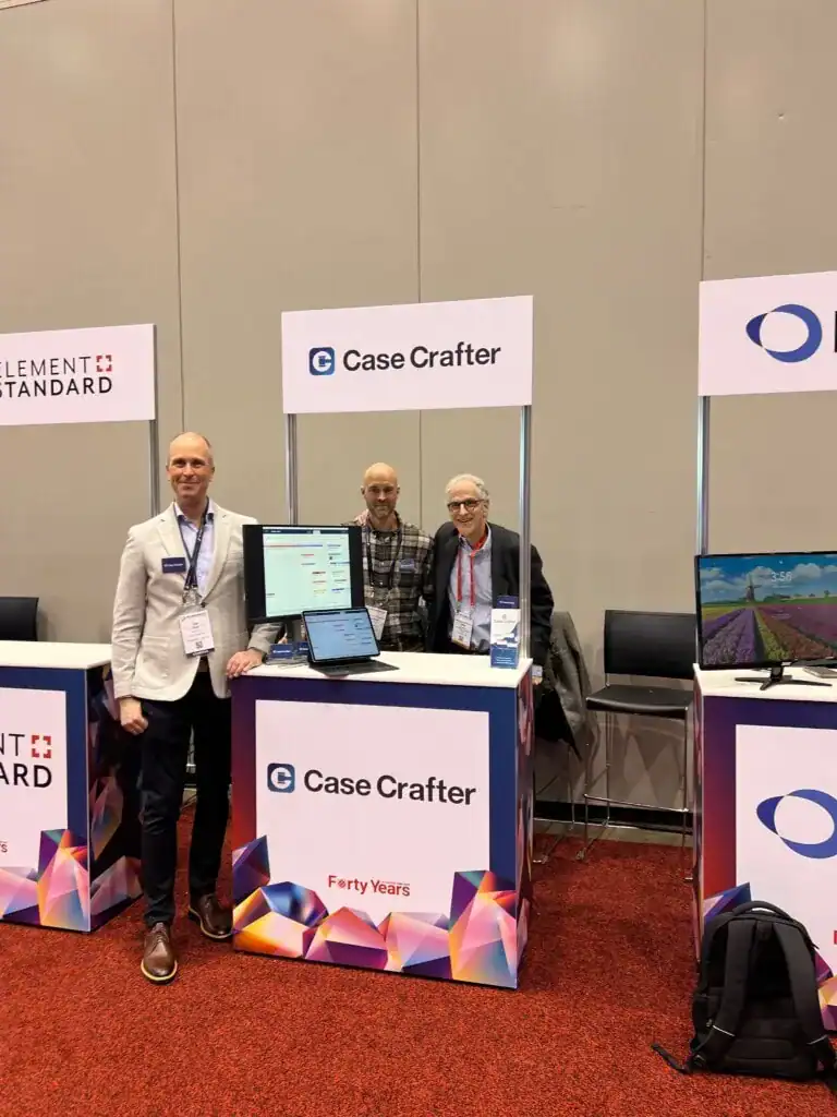 three people standing by a stand on aba techshow