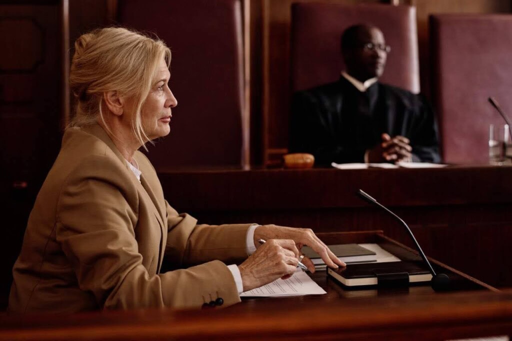 Female witness listening to prosecutor in a grand jury proceeding
