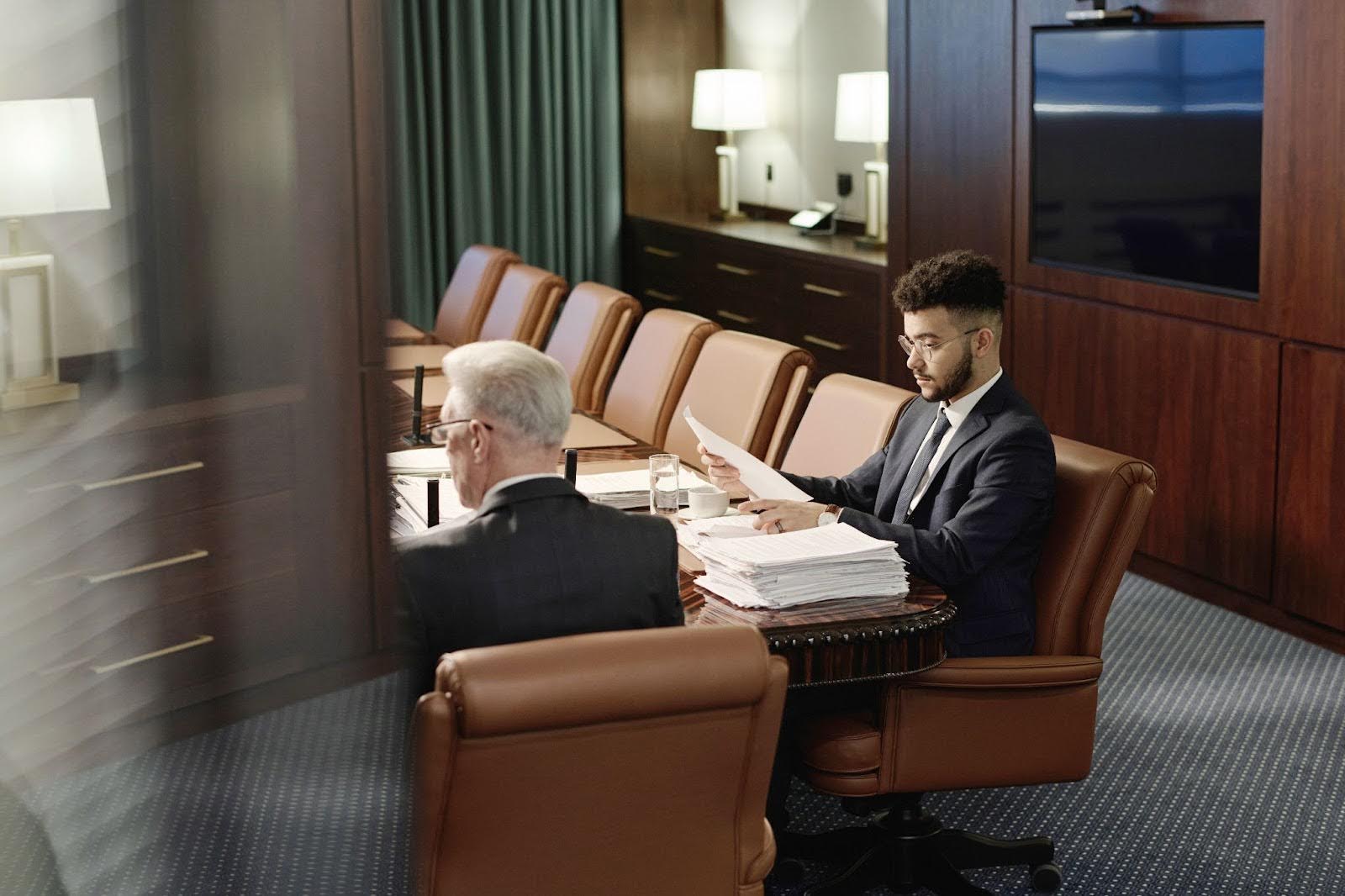 Counsel colleagues sitting around a table and reviewing case documents