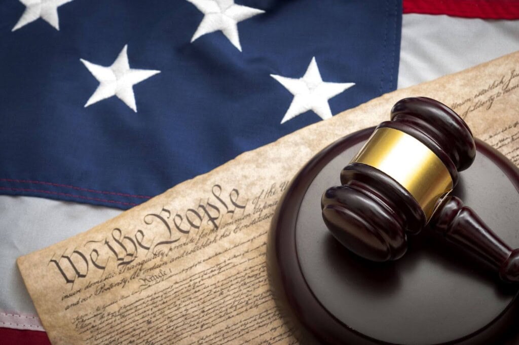 A gavel with the American flag in the background.