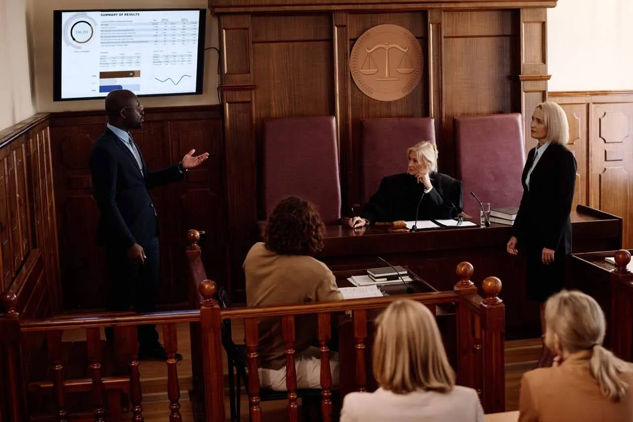 Lawyer presents case chronology on a television screen in front of a judge