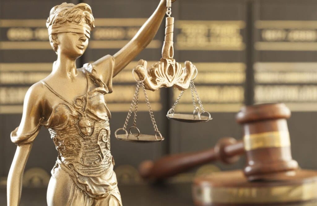 A golden statue with a law balance scale.