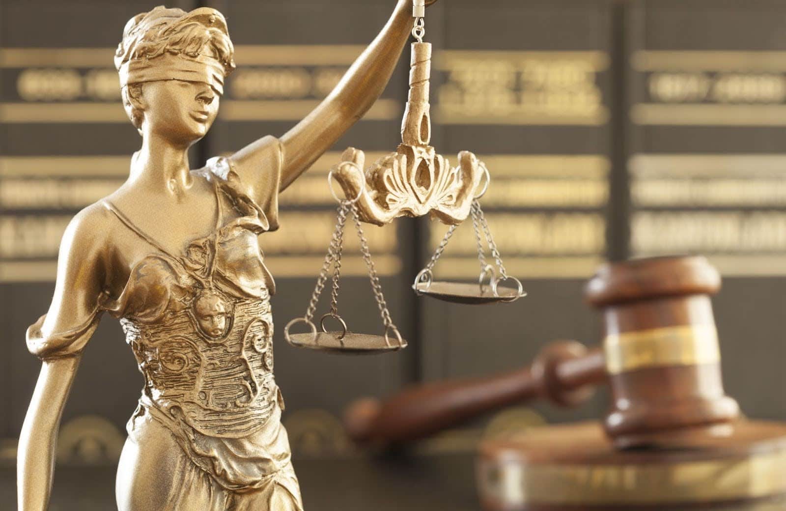 A golden statue with a law balance scale.